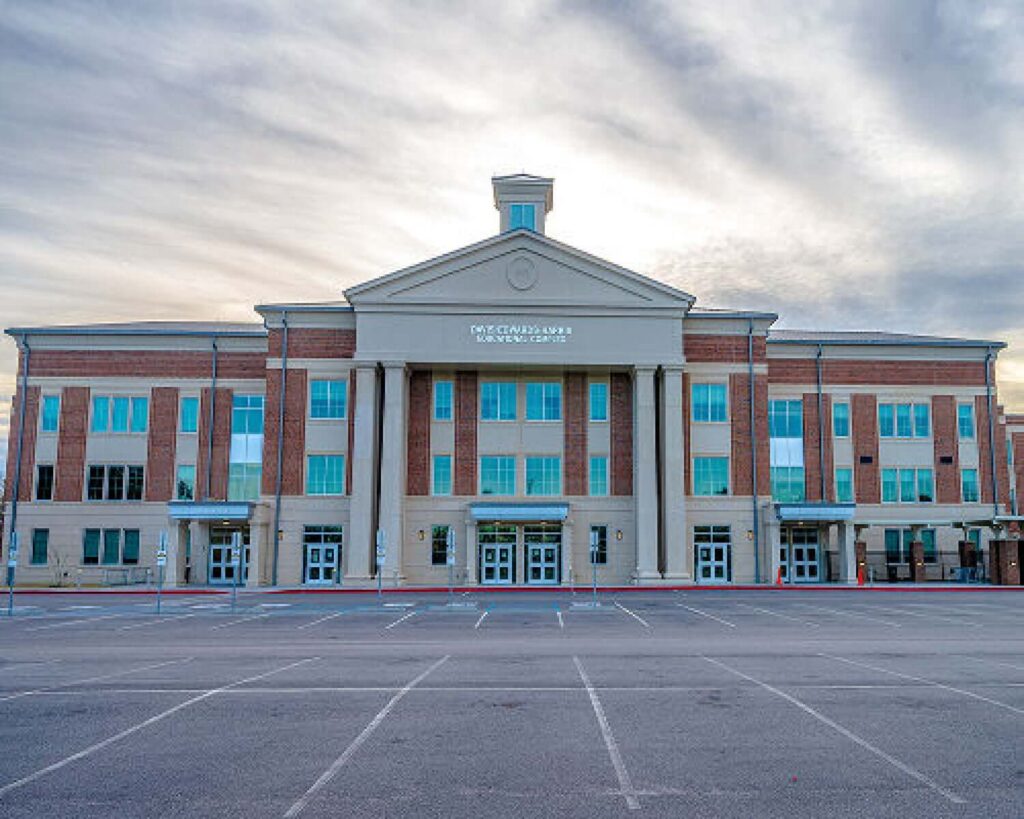 the front of the robert w groves k-12 davis edwards harris educational complex after construction has been completed