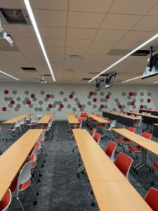 inside a classroom with rows of tables and chairs at the university of south carolina east tower
